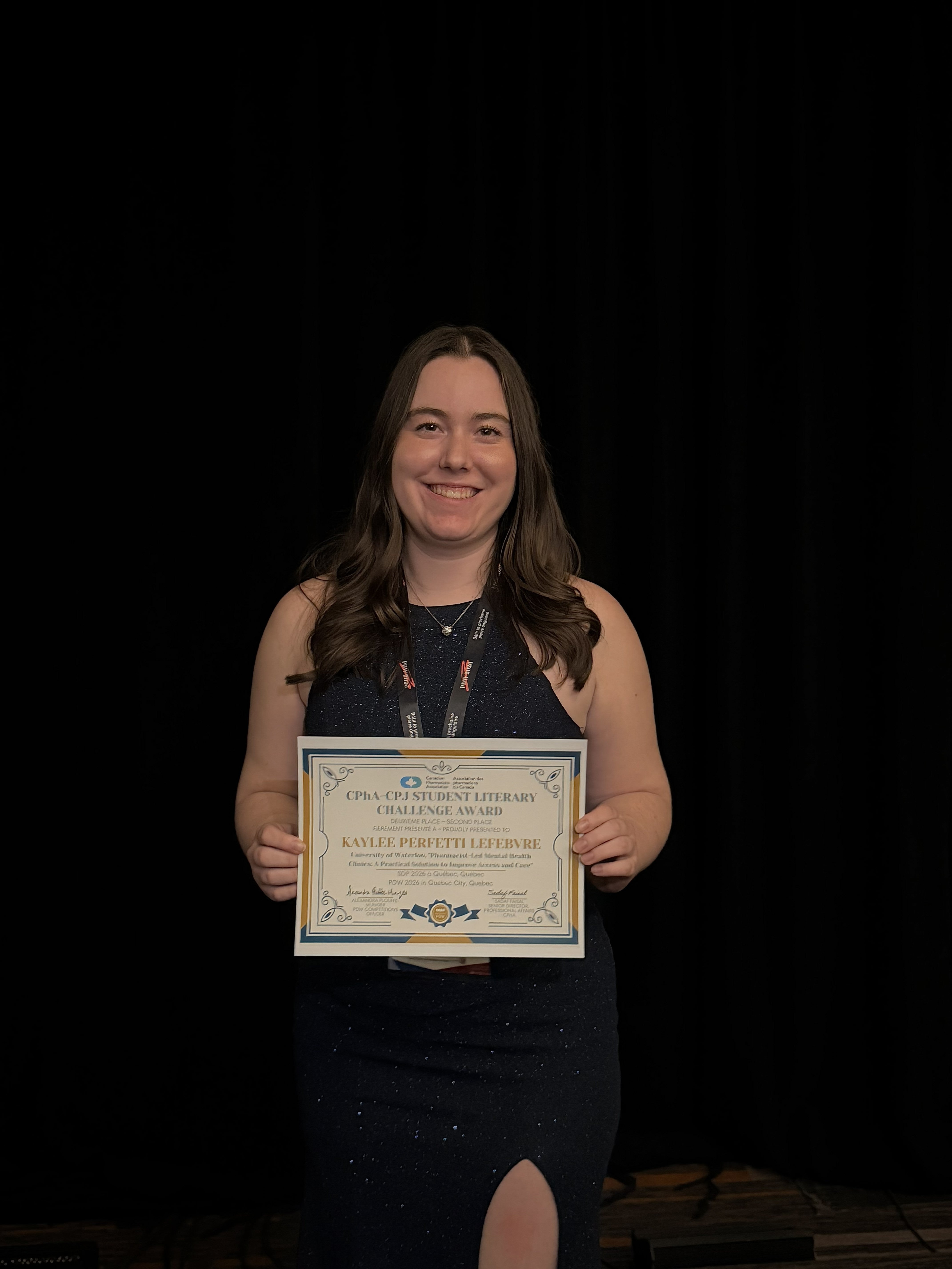 A student holding up an award