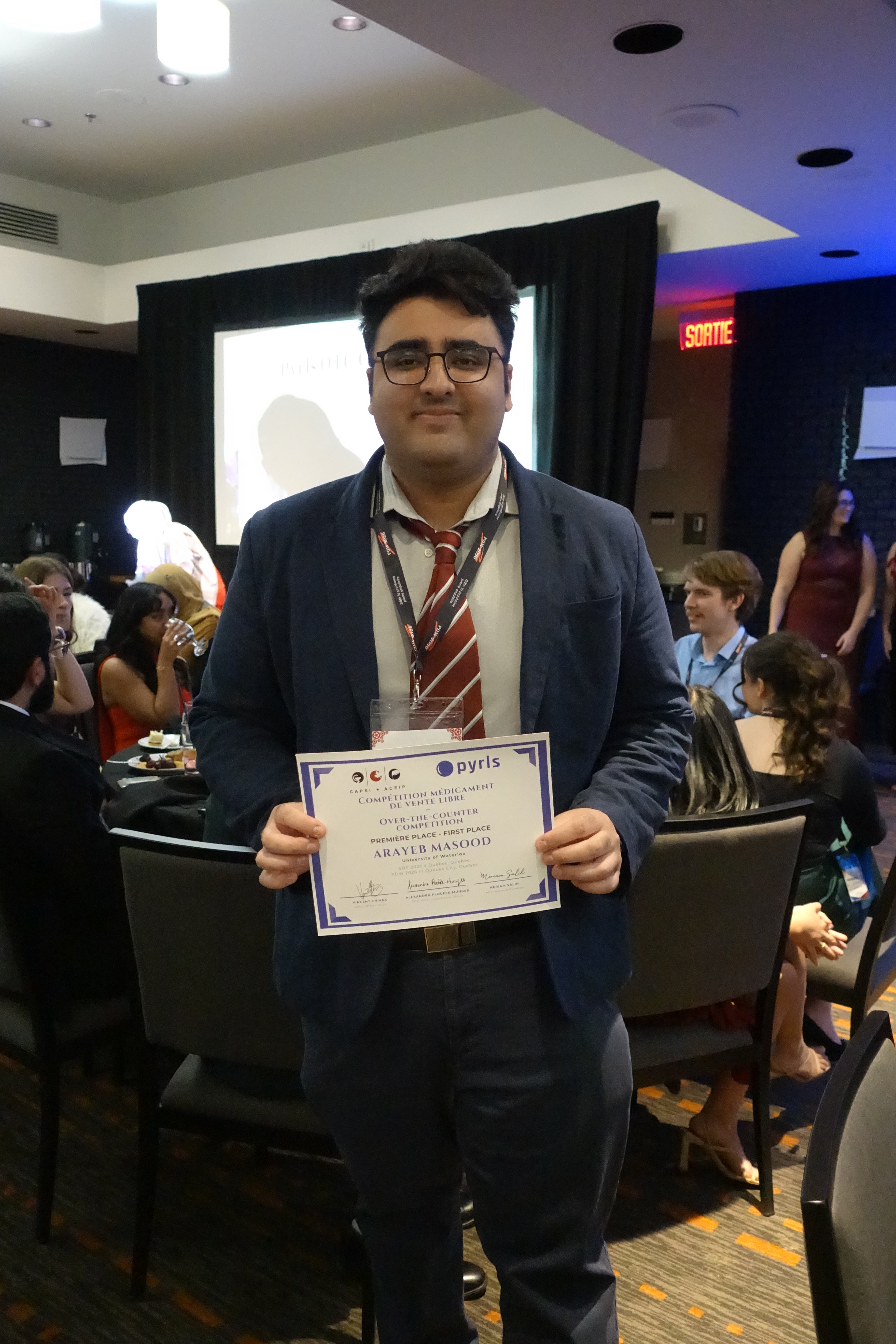 A student holding up an award