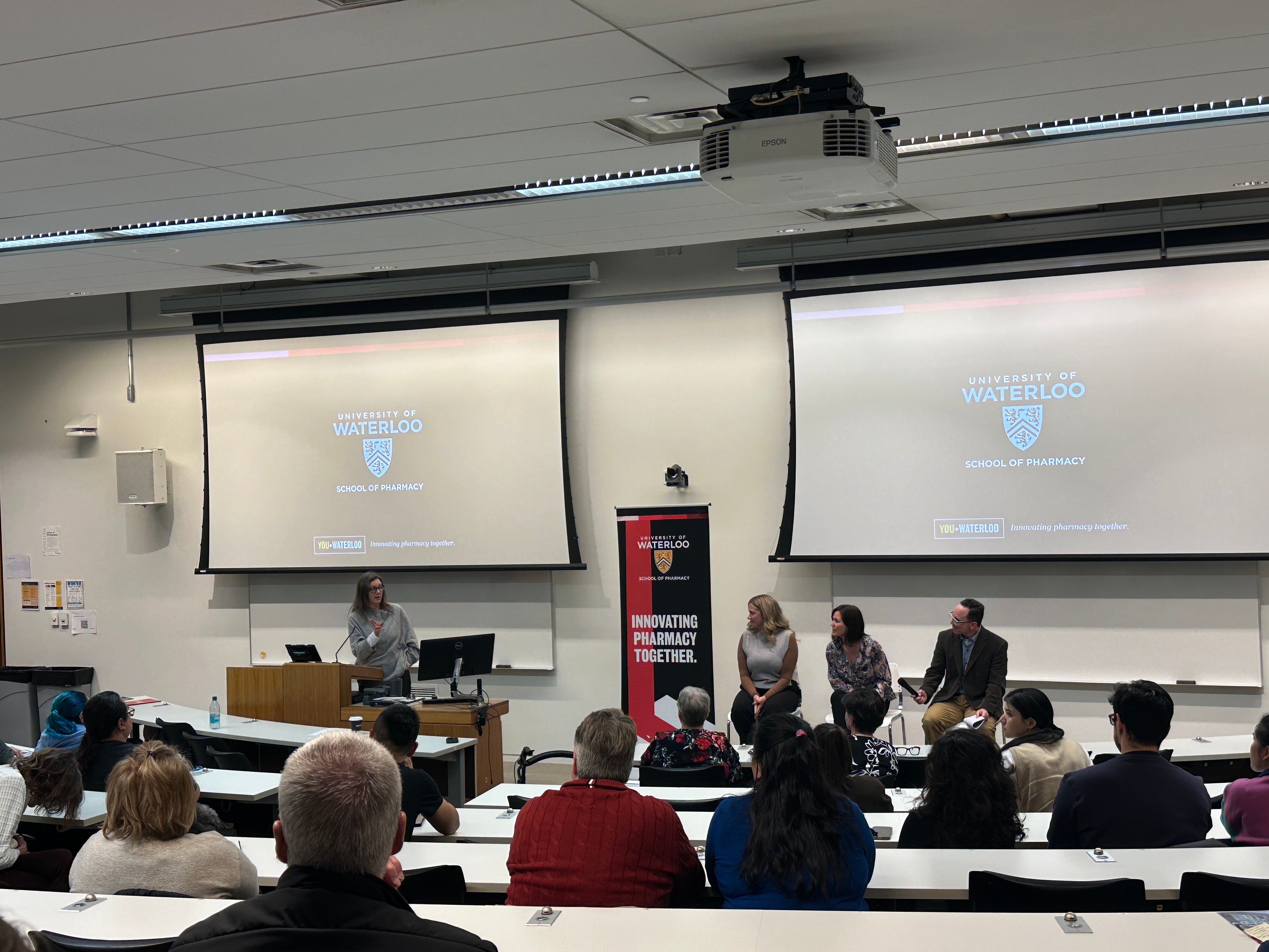 A panel of experts in discussion in front of a classroom