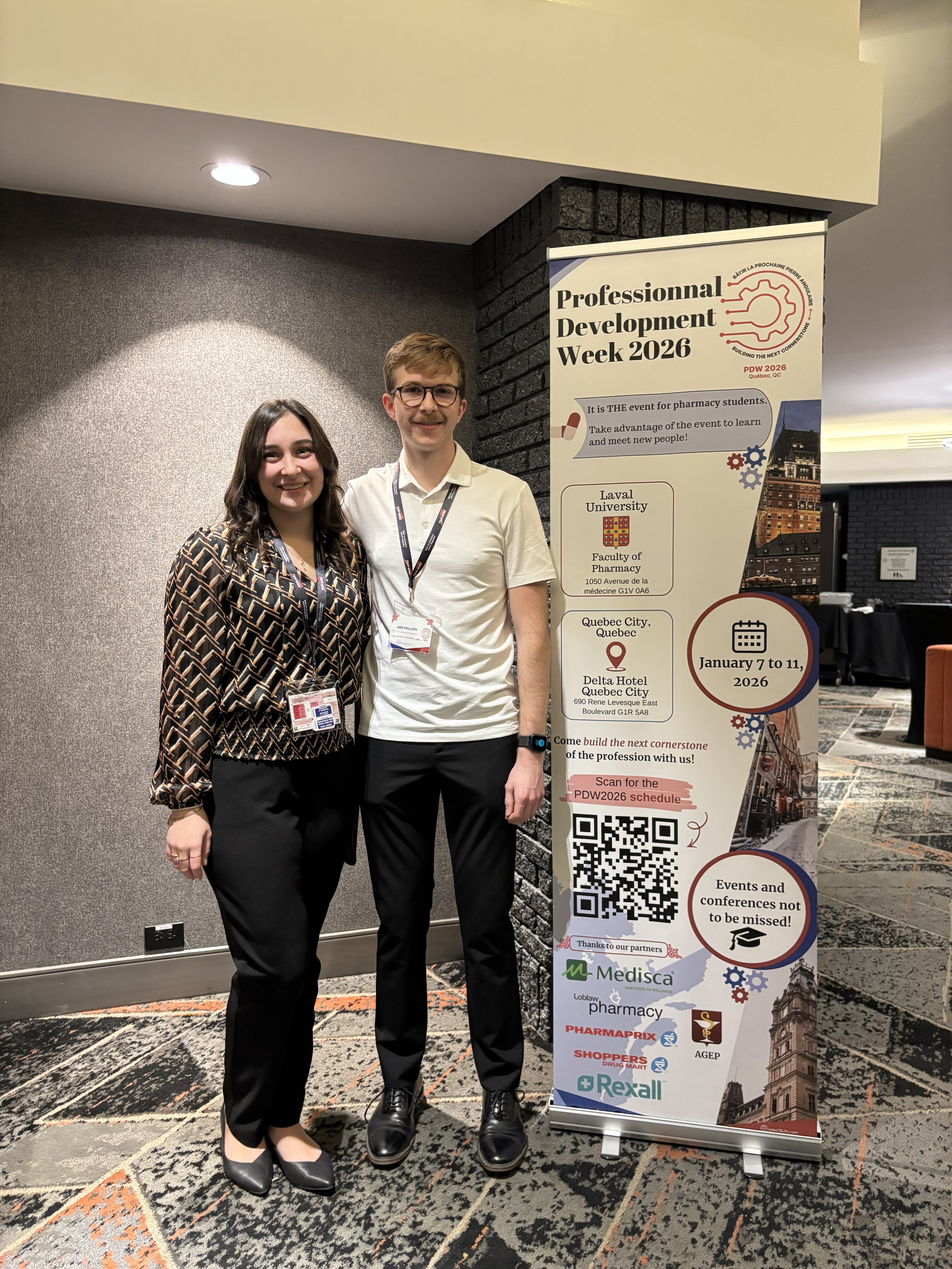 Students standing next to a banner
