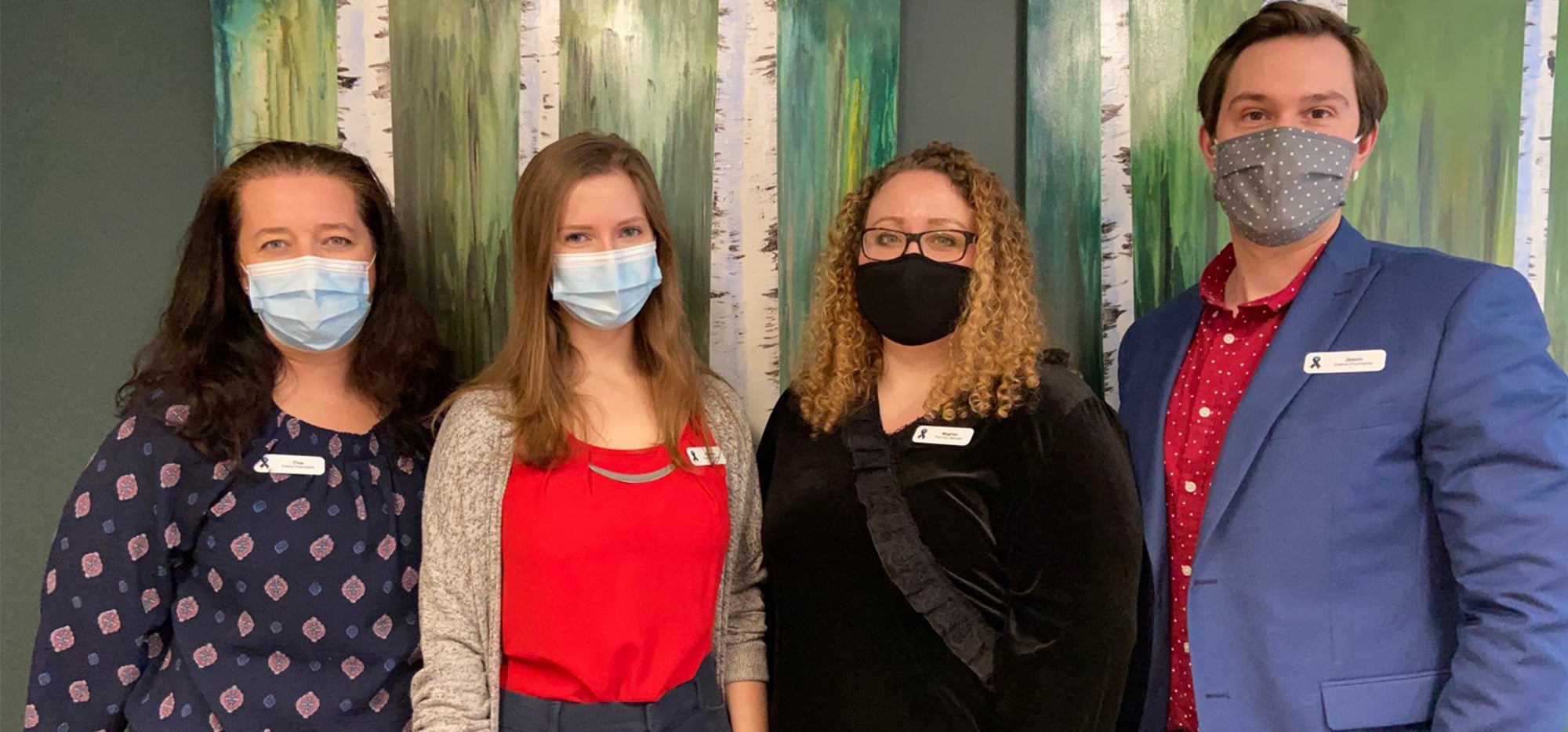 Four staff members of Extend in the pharmacy wearing masks