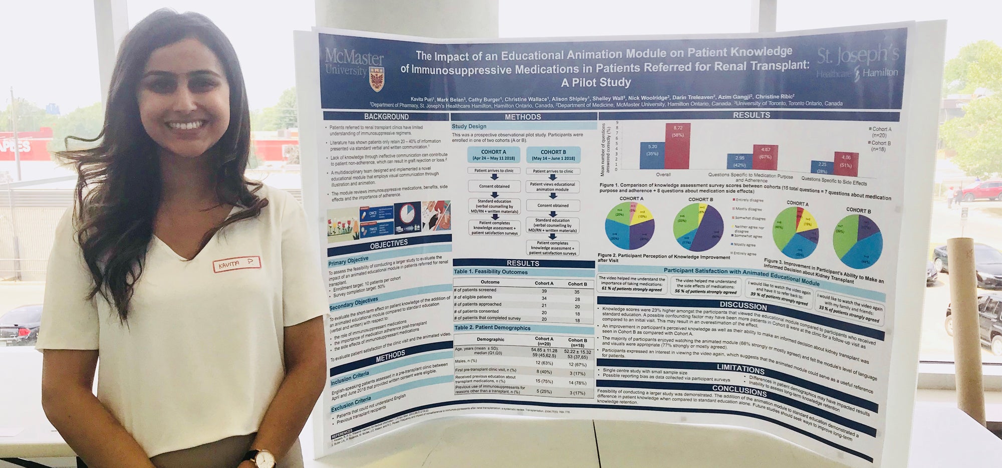 Kavita standing with her research poster