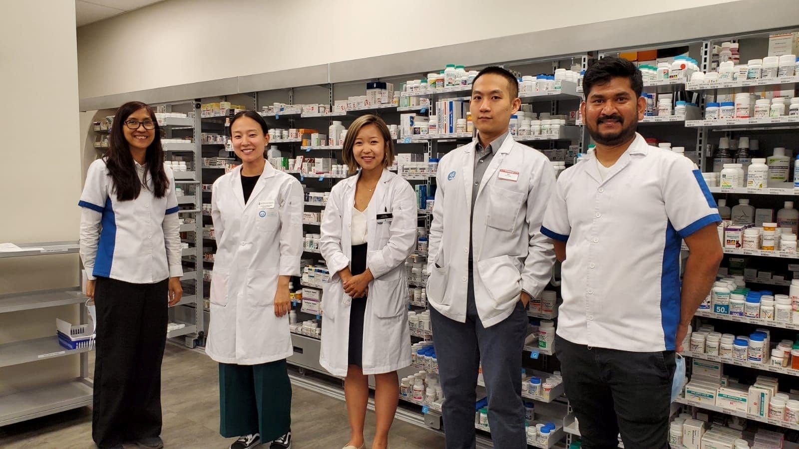 Lana with coworkers at the pharmacy