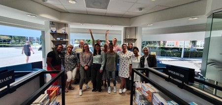 MacKenzie and Amsterdam pharmacy team at a Nieuwendammer Apotheek site.
