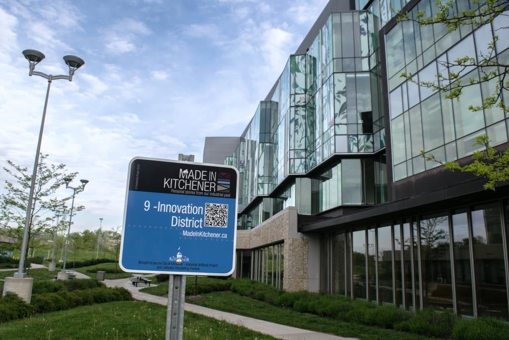 School of Pharmacy behind Made in Kitchener Stop 9 sign for Innovation District