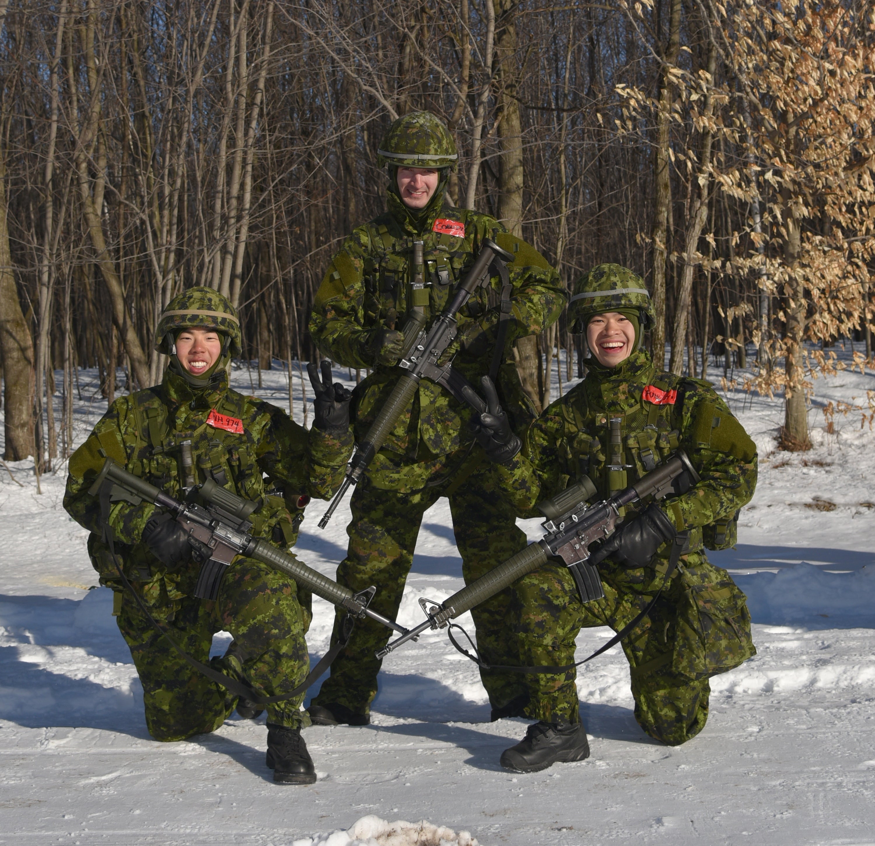 Sean and two comrades in the snow wearing military attire