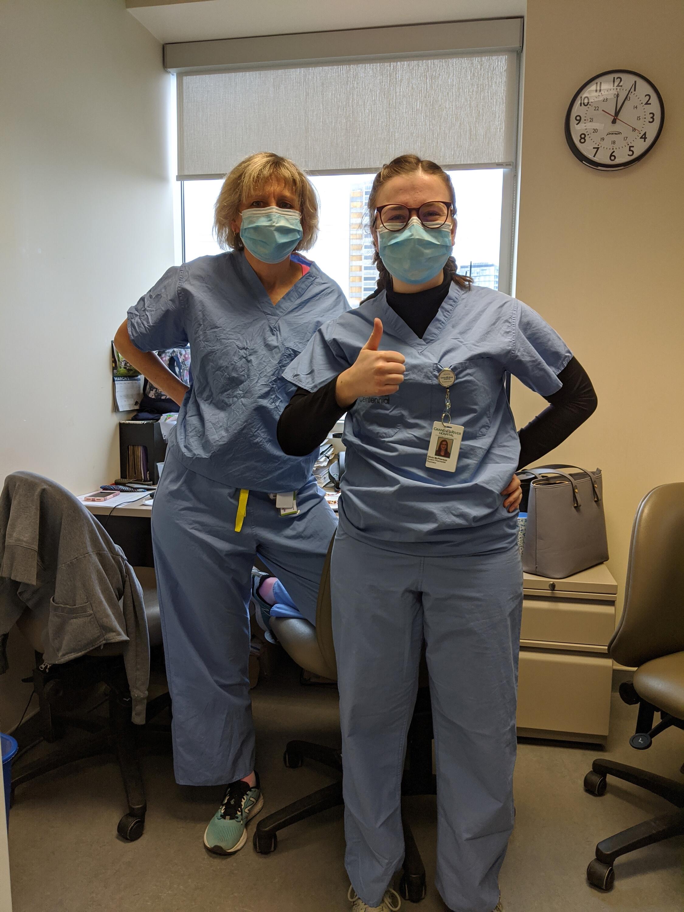 Olivia and supervisor wearing scrubs and face masks