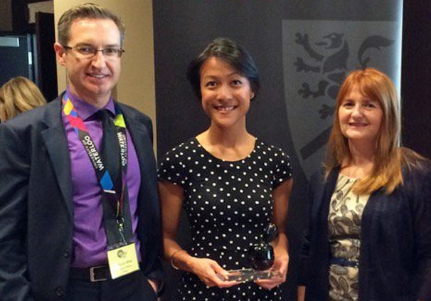 Experiential team members standing with co-op employer award winner