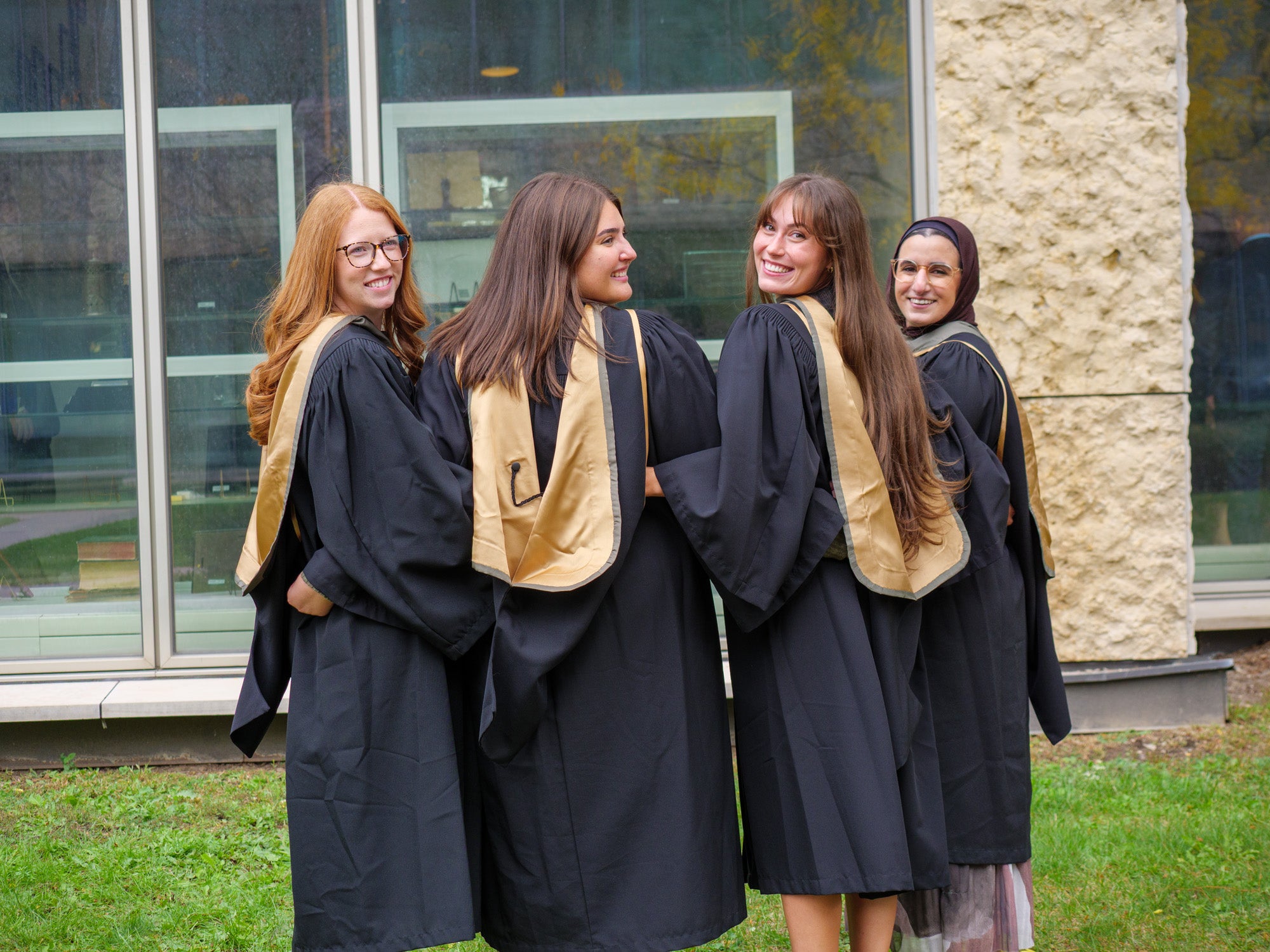 A group of students looking over their shoulders smiling