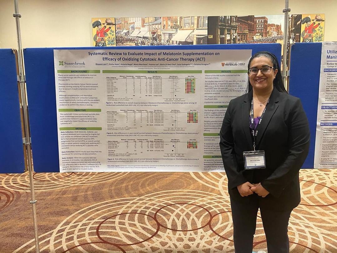 Bhawani Jain stnading in front of her research poster