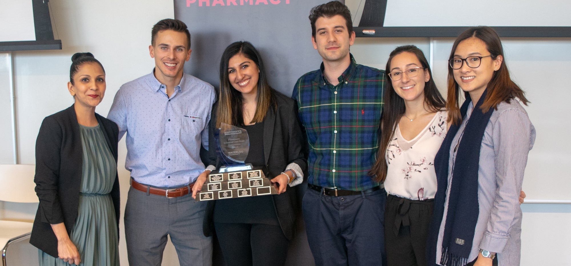 A group of students holding an award