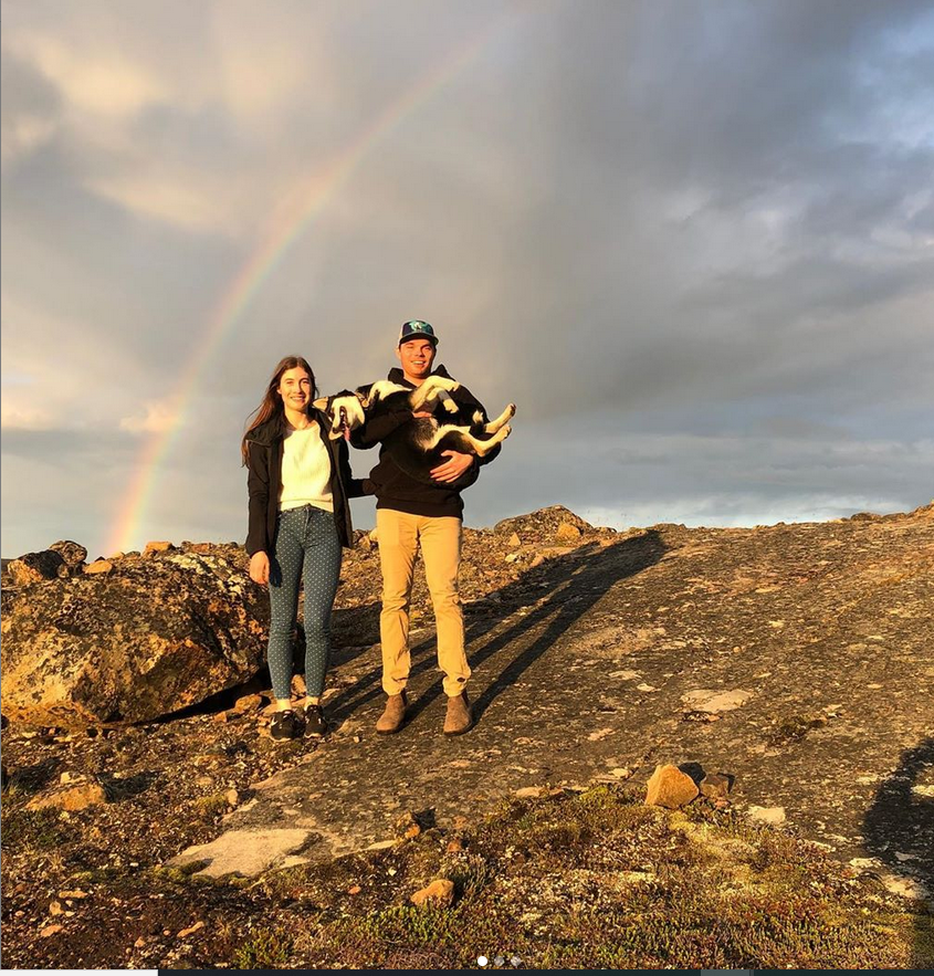 Jenna and Chris in front of a rainbow