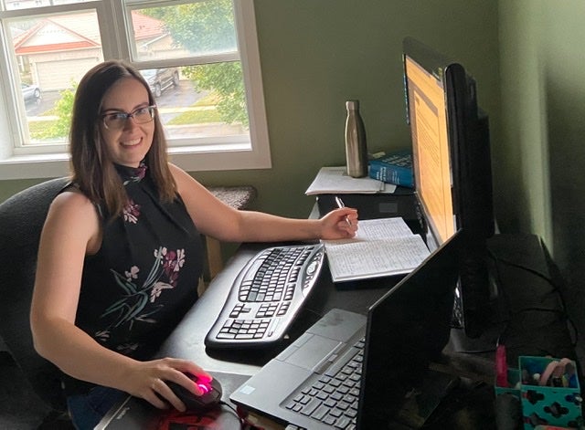 Caitlin Carter sitting ath er computer in her work from home office