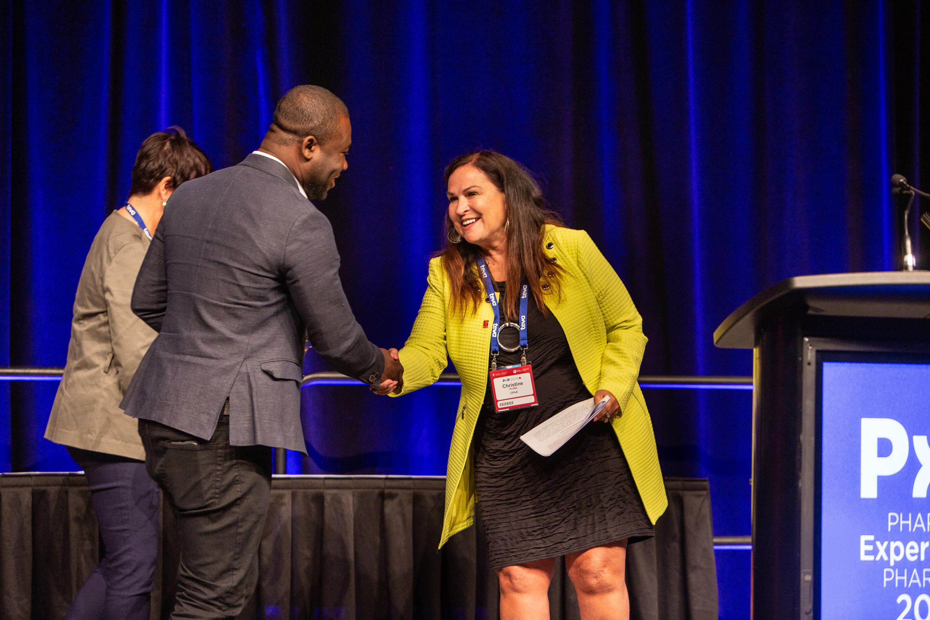 Michael Kani shaking hands with CPhA Chair Christine Hrudka