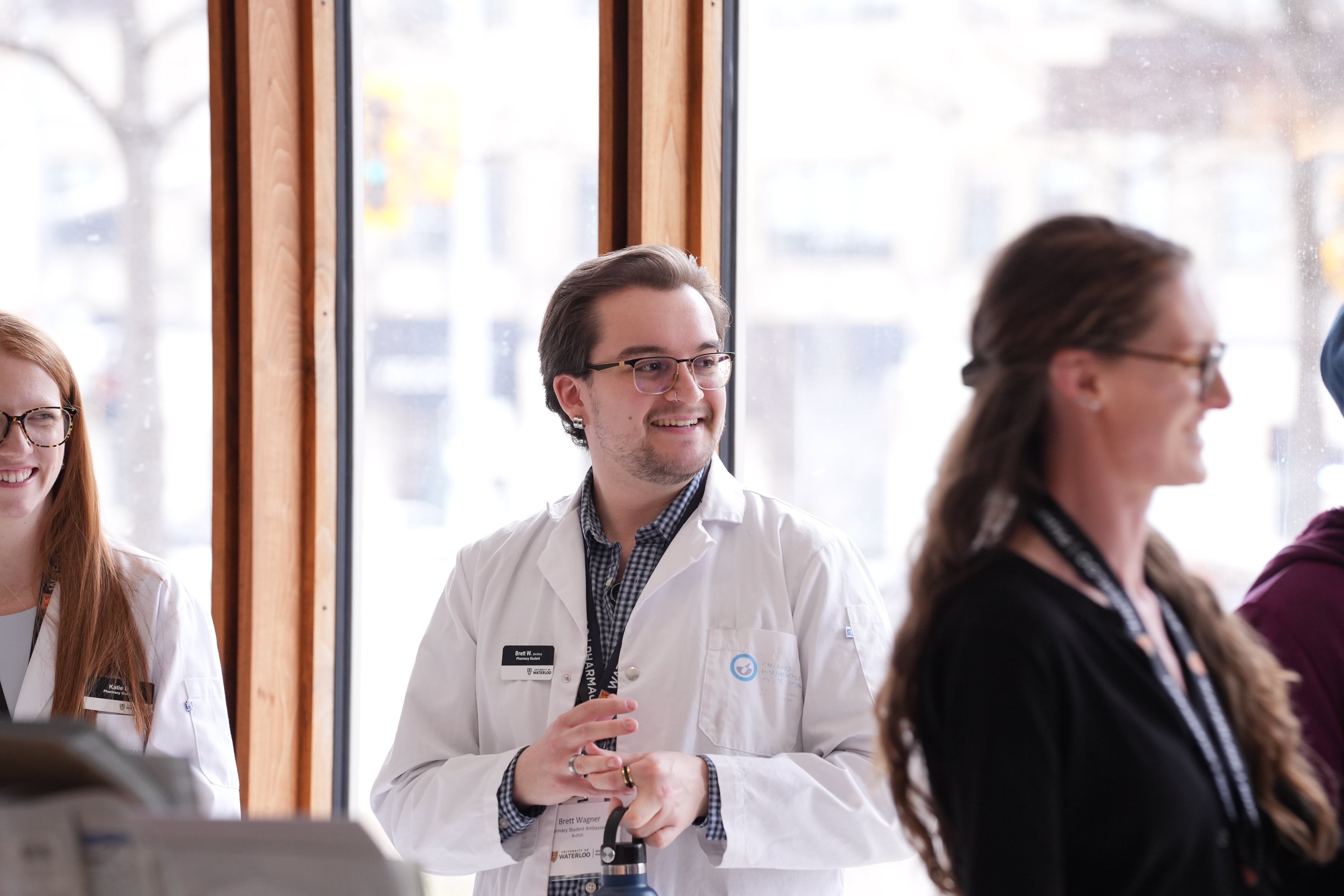 Student in white coat smiling