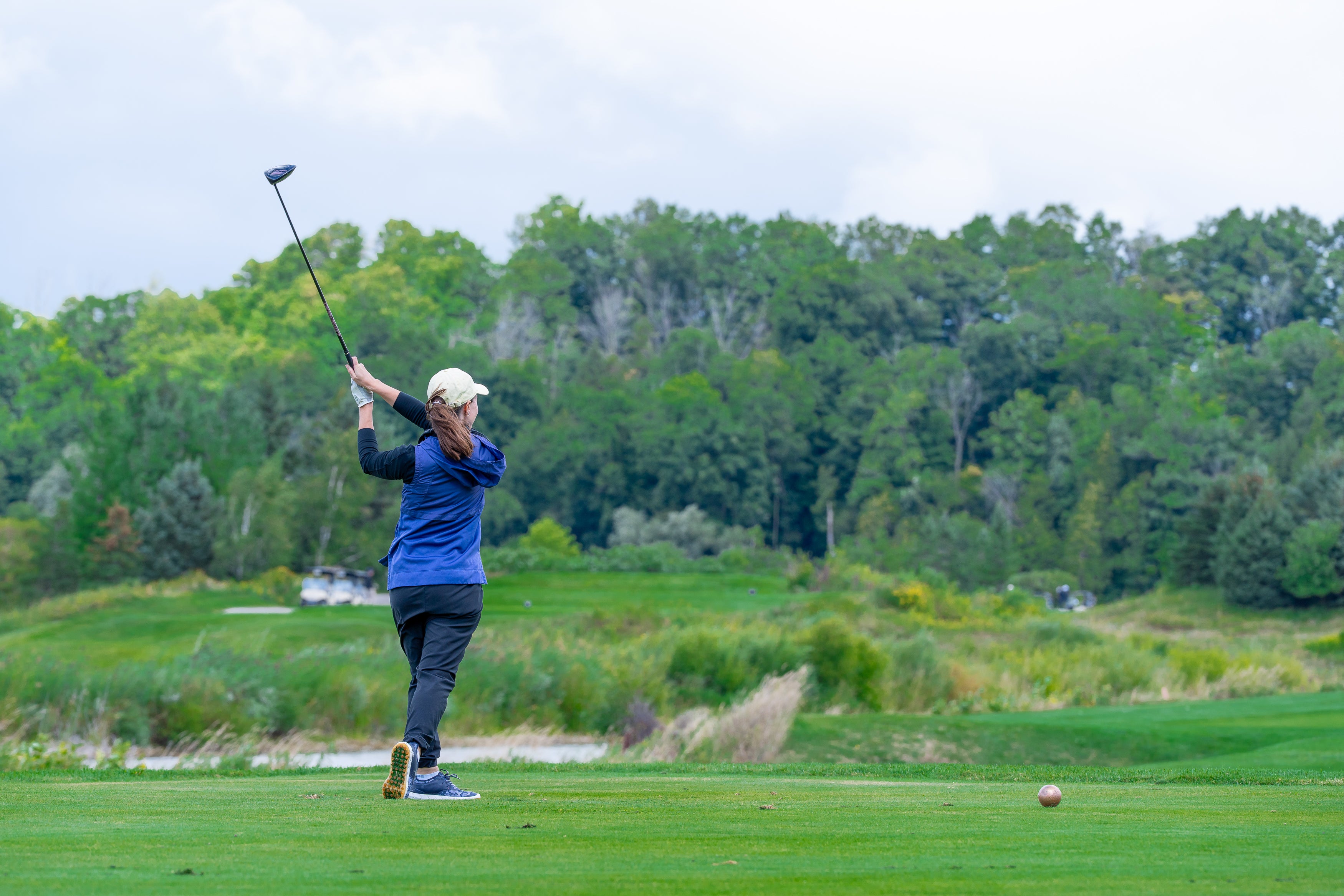 A woman playing golf
