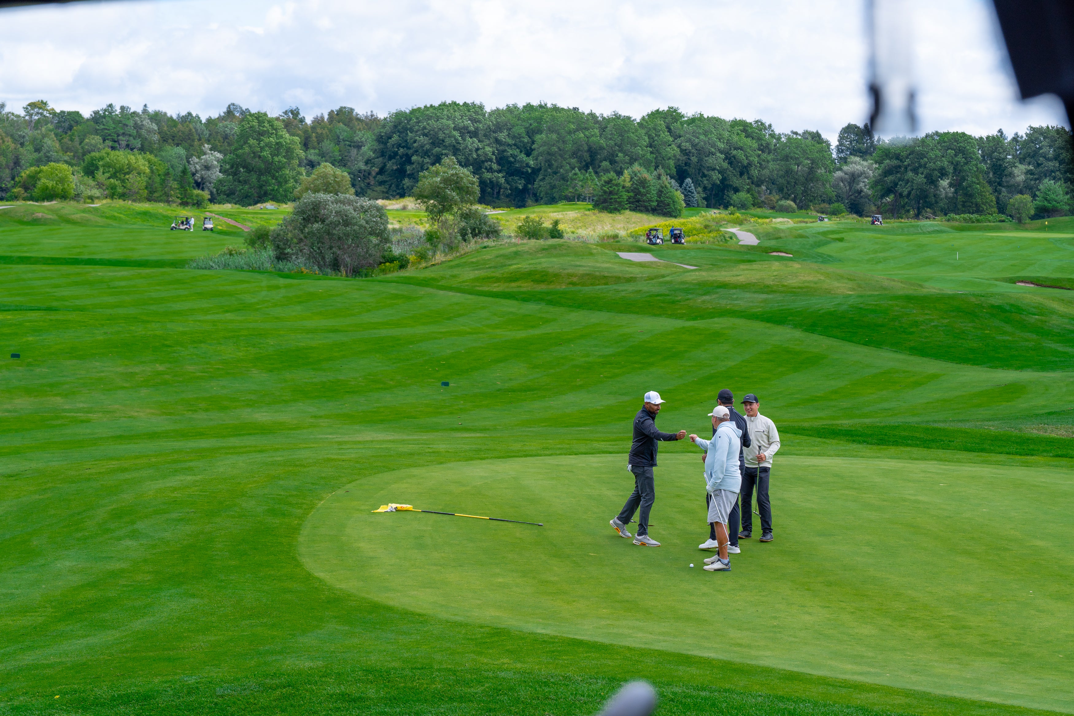 People celebrating on the golf green