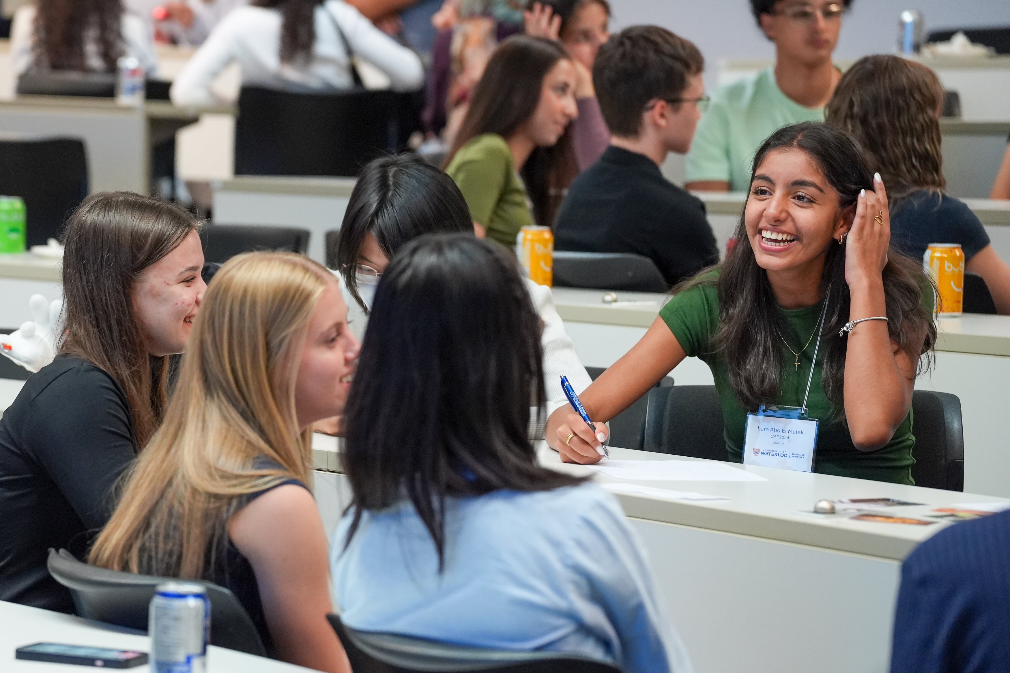 Students smiling in a classroom in discussion