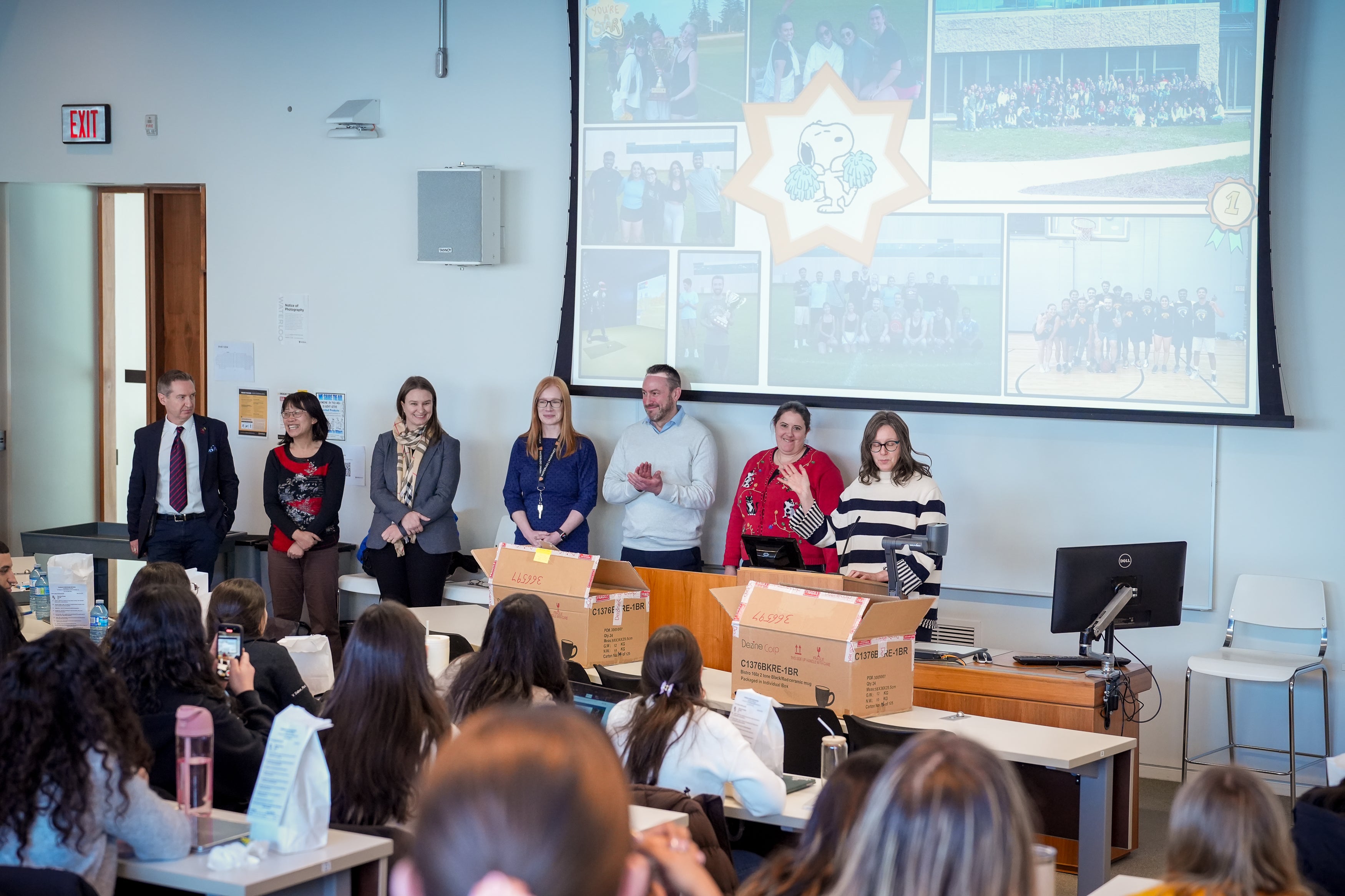 Professors at the front of a classroom 
