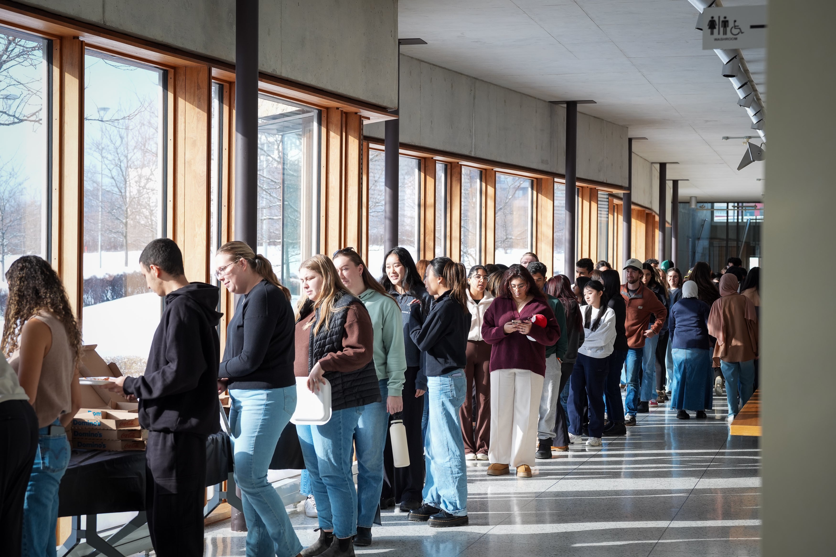 Students lined up to grab pizza