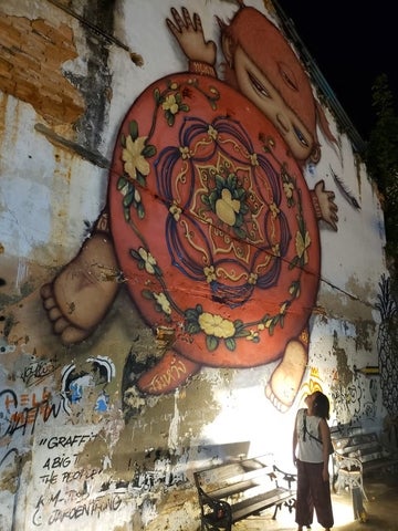 Janet Jones in front of mural