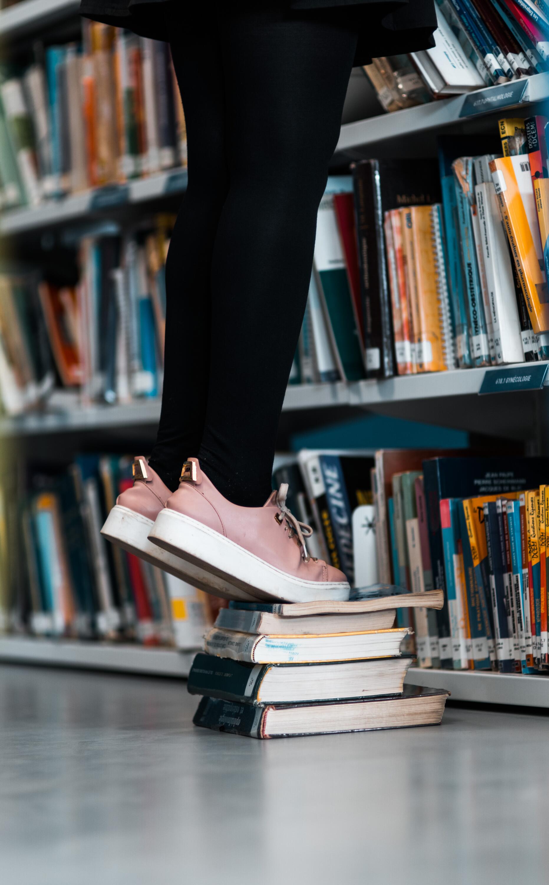 standing on books to see above