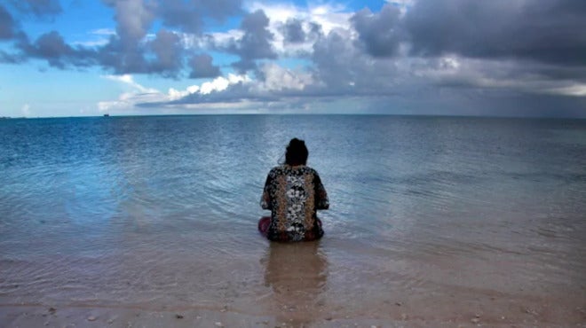 Woman sitting in water