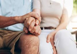 Elderly couple holding hands