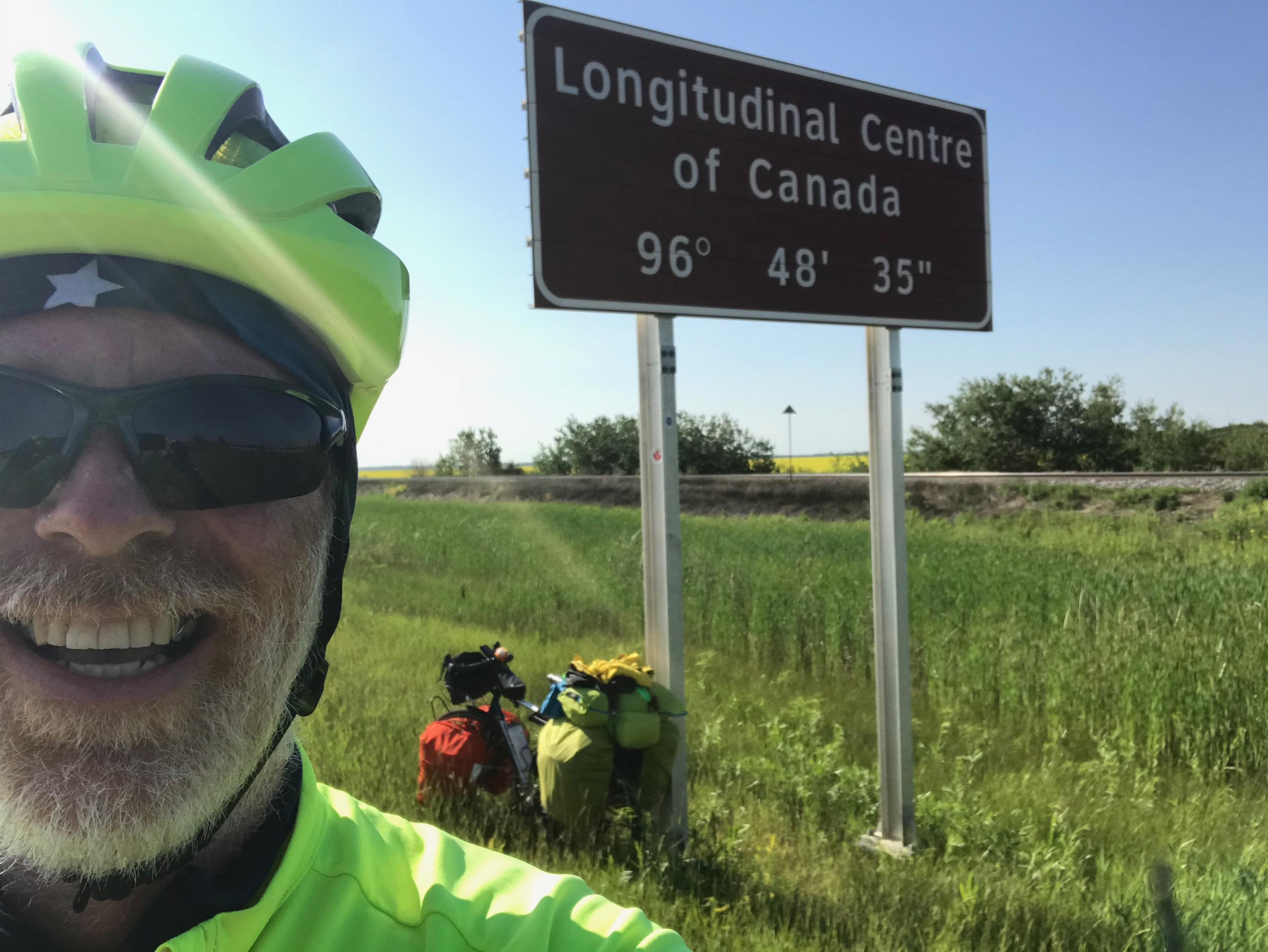 Greg Andres in front of sign 