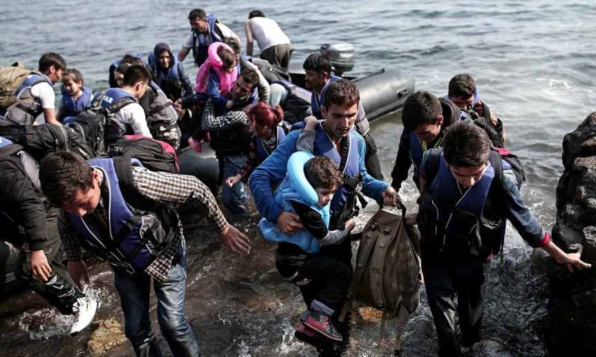 Syrian refugees getting off boat