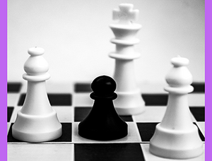 black pawn on a chess board surrounded by white king and bishops