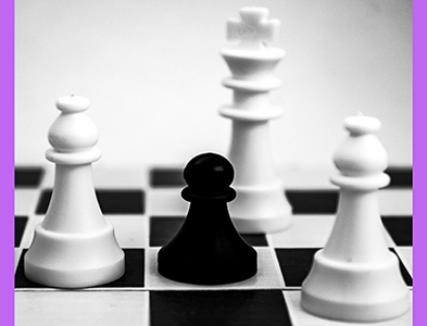 black pawn on a chess board surrounded by white king and bishops