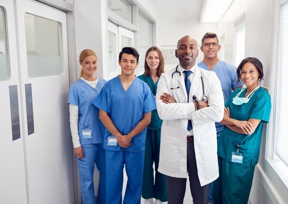 Doctors and nurses standing in a hospital hallway