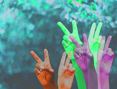multiple hands holding up peace sign