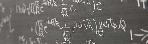 Physics equations on a chalkboard.