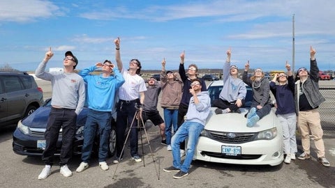 Physics students observing the eclipse.