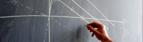 Hand writing on a chalk board.