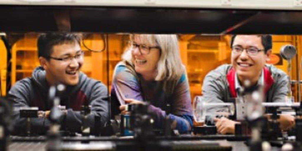 Donna Strickland and her students share a laugh in the lab