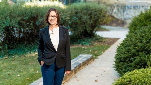 Woman walking on campus.