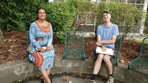 Urja Nandivada and Prof. Jim Martin Sitting Beside Each Other on a Bench