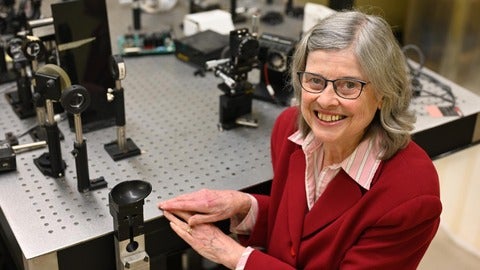 Professor Melanie Campbell with Optical Equipment