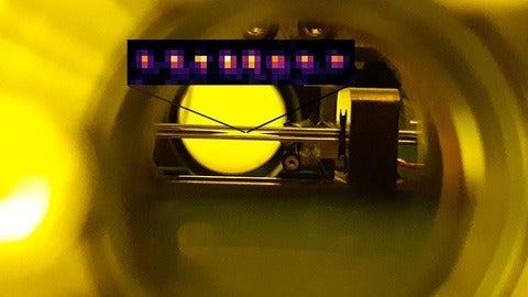 View from a glass window of an ultra-high vacuum chamber housing an ion trapping apparatus.