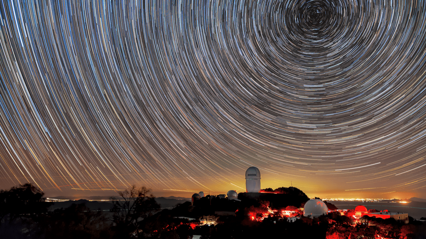 Stars leaving streaks of light as they traverse the night sky due to the Earth rotating.
