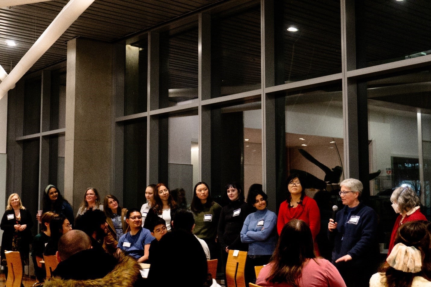 Mentoring night with people sitting and listening to the speakers.