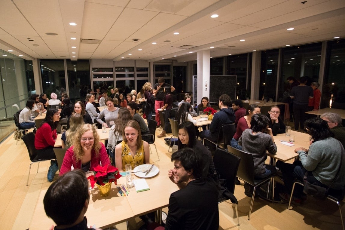 Mentoring night with small groups gathered intimately around separate tables.