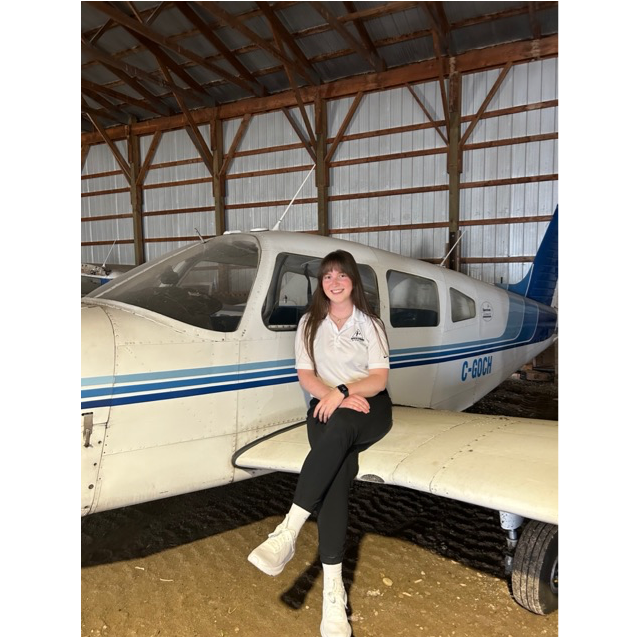 Chloe Muhl in an airplane hanger