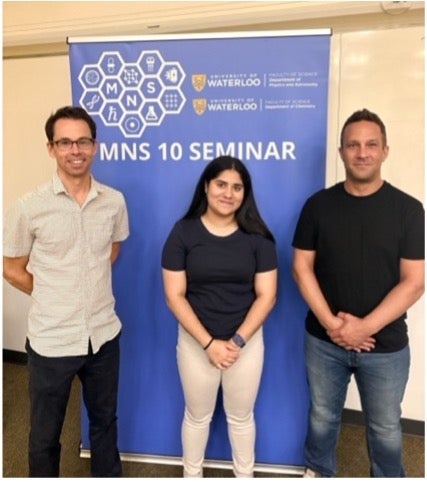Advisors and student pose in front of banner "MNS 10 Seminar".