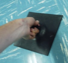 Photograph of hand tugging on atmospheric pressure demonstrator