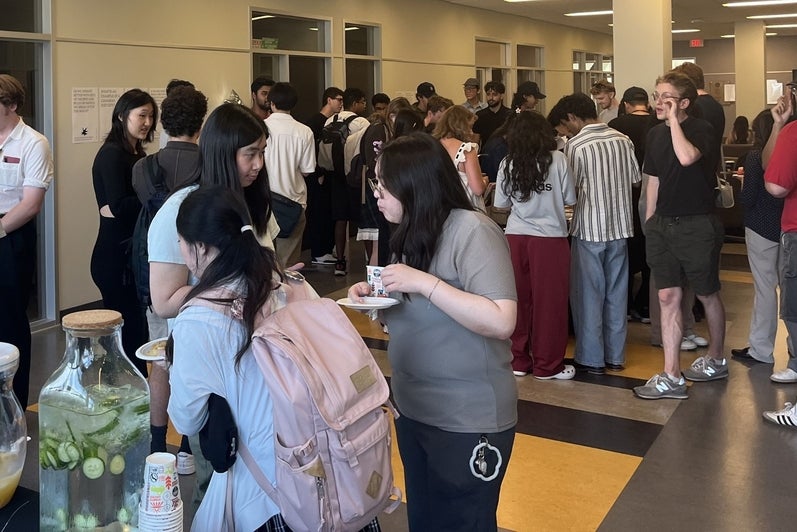 Group of students gathering together to eat snacks 