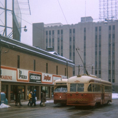 Toronto streetcar pictured near a series of restaurants.